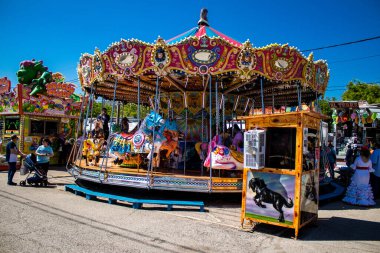 Seville, Spain - May 05, 2022 Feria de Sevilla funfair, the attractions and rides are open again, This party is back after two years of absence due to an epidemic of covid