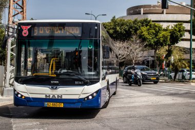 Tel Aviv, Israel - May 07, 2022 Israeli public bus driving through the streets of Tel Aviv during the coronavirus outbreak hitting Israel, wearing a mask is mandatory