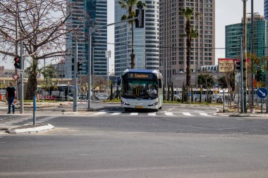 Tel Aviv, Israel - May 07, 2022 Israeli public bus driving through the streets of Tel Aviv during the coronavirus outbreak hitting Israel, wearing a mask is mandatory
