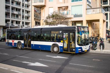 Tel Aviv, Israel - May 07, 2022 Israeli public bus driving through the streets of Tel Aviv during the coronavirus outbreak hitting Israel, wearing a mask is mandatory