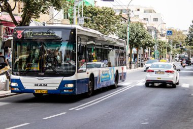 Tel Aviv, Israel - May 07, 2022 Israeli public bus driving through the streets of Tel Aviv during the coronavirus outbreak hitting Israel, wearing a mask is mandatory