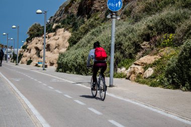 Tel Aviv, İsrail - 07 Mayıs 2022 İsrail 'de Tel Aviv sokaklarında bisikletle gezen insanlar