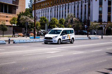 Seville, Spain - May 09, 2022 Taxi driving through the streets of Seville during the coronavirus outbreak hitting Spain, wearing a mask is mandatory