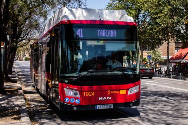 Seville, Spain - May 09, 2022 Bus driving through the streets of Seville during the coronavirus outbreak hitting Spain, wearing a mask is mandatory