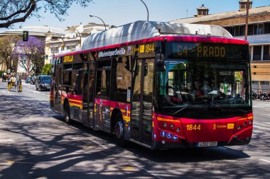 Seville, Spain - May 09, 2022 Bus driving through the streets of Seville during the coronavirus outbreak hitting Spain, wearing a mask is mandatory