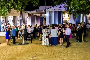 Carmona, İspanya - 11 Mayıs 2022, Feria de Carmona, insanlar arkadaşlarıyla içki içip flamenko dansı yapıyorlar, bu kutlama iki yıllık yokluğun ardından bir covid salgını nedeniyle geri döndü.