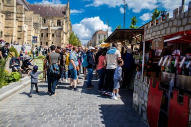 Reims, Fransa - 28 Mayıs 2022 Johanniques şenlikleri sırasında ortaçağ pazarında gezinen ziyaretçiler, Coronavirus salgınının ardından iki yıllık bir aradan sonra geri döndüler.