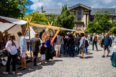 Reims, Fransa - 28 Mayıs 2022 Johanniques şenlikleri sırasında ortaçağ pazarında gezinen ziyaretçiler, Coronavirus salgınının ardından iki yıllık bir aradan sonra geri döndüler.