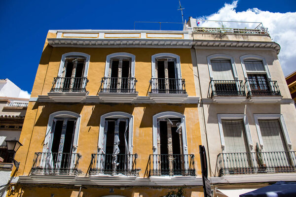 Seville, Spain - June 01, 2022 Facade of a building in the streets of Seville, an emblematic city and the capital of the region of Andalusia, in the south of Spain