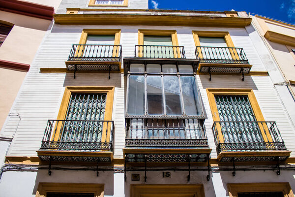 Seville, Spain - June 01, 2022 Facade of a building in the streets of Seville, an emblematic city and the capital of the region of Andalusia, in the south of Spain