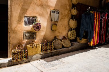 Fez, Morocco - June 12, 2022 The souks of Fez located in the medina are traditional Arab markets that offer all kinds of products like fabrics, food products, makeup and household appliances clipart