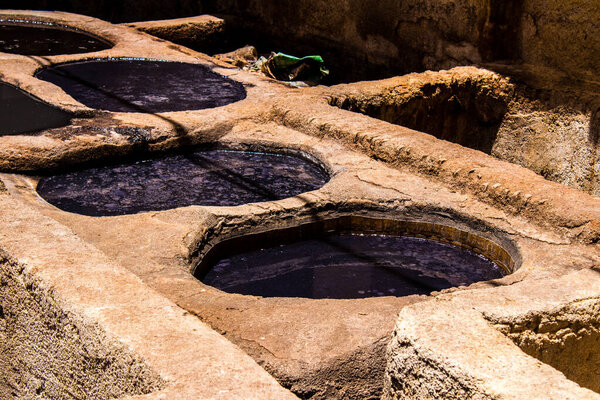 Fez, Morocco - June 13, 2022 Chouara Tannery, The dyeing vats at Chouara are among the Fez medina most iconic sights. The ancient craft of tanning and dyeing, in all its visceral authenticity
