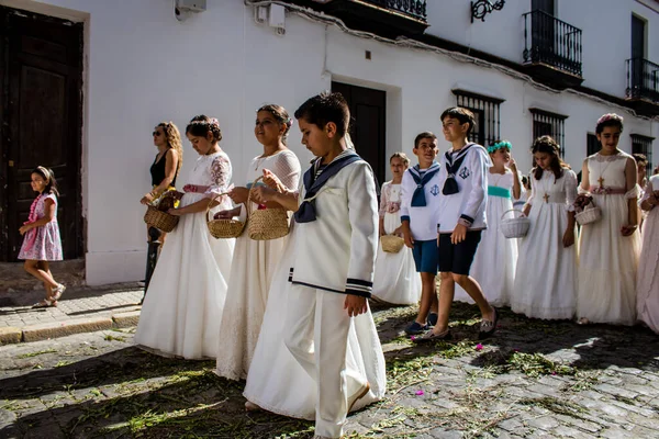 Carmona, İspanya - 19 Haziran 2022 Carmona Corpus Christi, Santa Maria Kilisesi 'ne giden genç çocuklarla dolu dini geçit töreni.