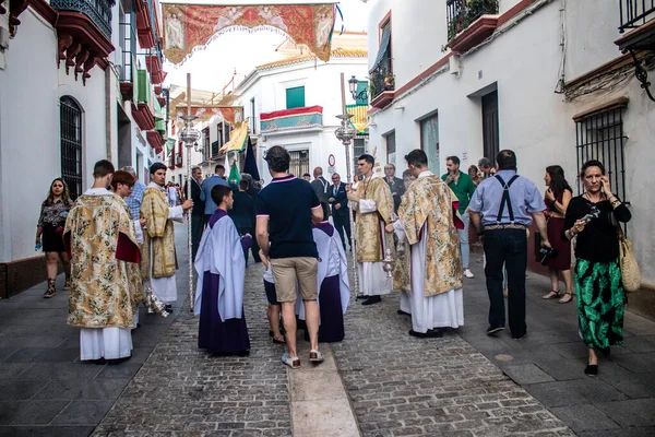Carmona, İspanya - 18 Haziran 2022 Carmona Corpus Christi, sokaklardaki dini tören alayı, San Blas Virgen kilisesinden Santa Maria kilisesine transfer, insanlar yolda dua ediyorlar.
