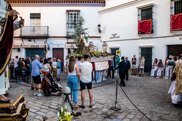 Carmona, İspanya - 18 Haziran 2022 Carmona Corpus Christi, sokaklardaki dini tören alayı, San Blas Virgen kilisesinden Santa Maria kilisesine transfer, insanlar yolda dua ediyorlar.