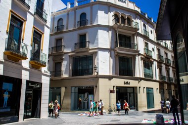 Seville, Spain - July 04, 2022 Facade of a building in the streets of Seville, an emblematic city and the capital of the region of Andalusia, in the south of Spain