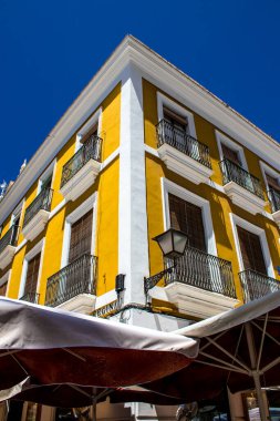 Seville, Spain - July 04, 2022 Facade of a building in the streets of Seville, an emblematic city and the capital of the region of Andalusia, in the south of Spain