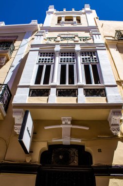 Seville, Spain - July 04, 2022 Facade of a building in the streets of Seville, an emblematic city and the capital of the region of Andalusia, in the south of Spain