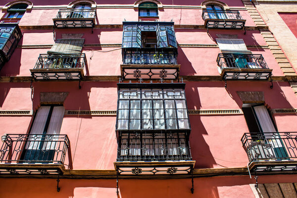 Seville, Spain - July 04, 2022 Facade of a building in the streets of Seville, an emblematic city and the capital of the region of Andalusia, in the south of Spain
