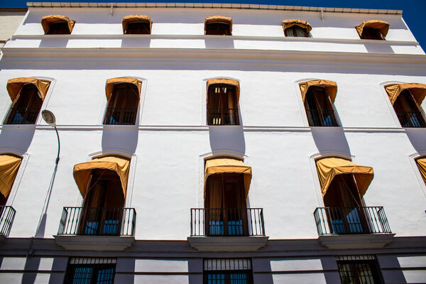 Seville, Spain - July 04, 2022 Facade of a building in the streets of Seville, an emblematic city and the capital of the region of Andalusia, in the south of Spain