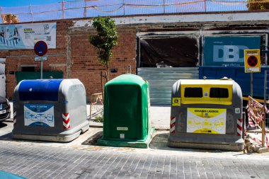 Seville, Spain - July 04, 2022 Garbage container in the streets of Seville, an emblematic city and the capital of the region of Andalusia, in the south of Spain
