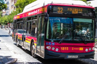 Seville, Spain - July 04, 2022 Bus driving through the streets of Seville during the coronavirus outbreak hitting Spain, wearing a mask is mandatory