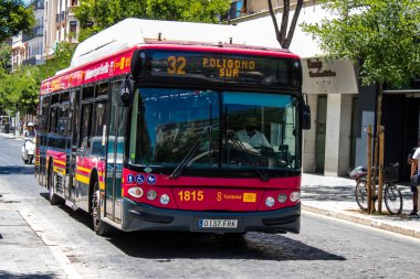 Seville, Spain - July 04, 2022 Bus driving through the streets of Seville during the coronavirus outbreak hitting Spain, wearing a mask is mandatory
