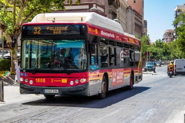 Seville, Spain - July 04, 2022 Bus driving through the streets of Seville during the coronavirus outbreak hitting Spain, wearing a mask is mandatory