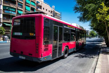 Seville, Spain - July 04, 2022 Bus driving through the streets of Seville during the coronavirus outbreak hitting Spain, wearing a mask is mandatory