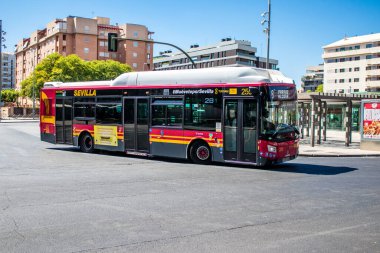 Seville, Spain - July 04, 2022 Bus driving through the streets of Seville during the coronavirus outbreak hitting Spain, wearing a mask is mandatory