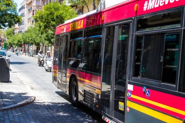 Seville, Spain - July 04, 2022 Bus driving through the streets of Seville during the coronavirus outbreak hitting Spain, wearing a mask is mandatory