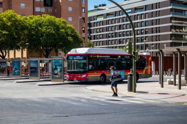 Seville, Spain - July 04, 2022 Bus driving through the streets of Seville during the coronavirus outbreak hitting Spain, wearing a mask is mandatory