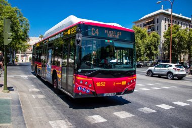 Seville, Spain - July 04, 2022 Bus driving through the streets of Seville during the coronavirus outbreak hitting Spain, wearing a mask is mandatory