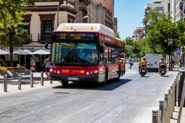 Seville, Spain - July 04, 2022 Bus driving through the streets of Seville during the coronavirus outbreak hitting Spain, wearing a mask is mandatory