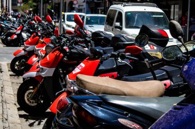 Seville, Spain - July 04, 2022 Scooters parked in the streets of Seville, an emblematic city and the capital of the region of Andalusia