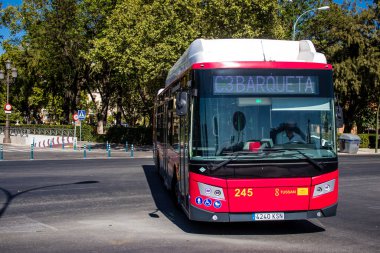 Seville, Spain - July 12, 2022 Bus driving through the streets of Seville during the coronavirus outbreak hitting Spain, wearing a mask is mandatory