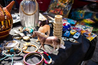Seville, Spain - July 14, 2022 Various objects sold at the Flea market, also known as Mercadillo Historico Del Jueves, locals are busy poking around looking for bargains in the narrow Calle Feria