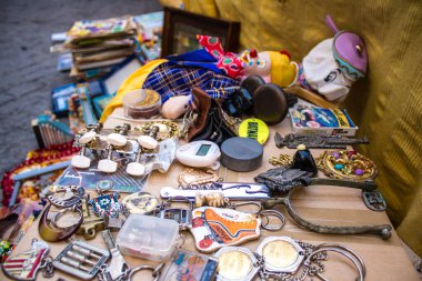 Seville, Spain - July 14, 2022 Various objects sold at the Flea market, also known as Mercadillo Historico Del Jueves, locals are busy poking around looking for bargains in the narrow Calle Feria