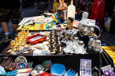 Seville, Spain - July 14, 2022 Various objects sold at the Flea market, also known as Mercadillo Historico Del Jueves, locals are busy poking around looking for bargains in the narrow Calle Feria