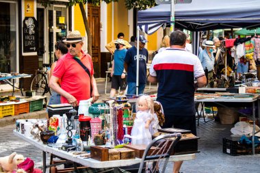 Seville, Spain - July 14, 2022 Various objects sold at the Flea market, also known as Mercadillo Historico Del Jueves, locals are busy poking around looking for bargains in the narrow Calle Feria