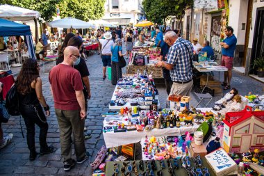 Seville, İspanya - 14 Temmuz 2022 Mercadillo Historico Del Jueves olarak da bilinen bit pazarında satılan çeşitli eşyalar, yerel halk dar Calle Feria 'da pazarlık aramakla meşgul.