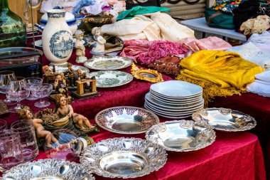 Seville, Spain - July 14, 2022 Various objects sold at the Flea market, also known as Mercadillo Historico Del Jueves, locals are busy poking around looking for bargains in the narrow Calle Feria