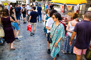 Seville, Spain - July 14, 2022 Various objects sold at the Flea market, also known as Mercadillo Historico Del Jueves, locals are busy poking around looking for bargains in the narrow Calle Feria