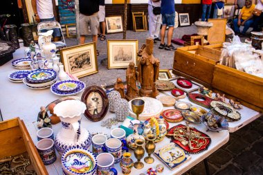 Seville, Spain - July 14, 2022 Various objects sold at the Flea market, also known as Mercadillo Historico Del Jueves, locals are busy poking around looking for bargains in the narrow Calle Feria