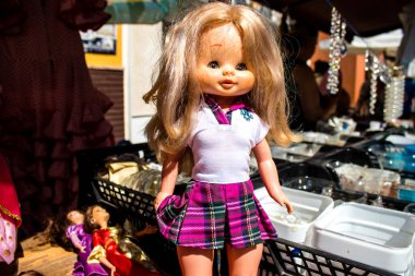 Seville, Spain - July 14, 2022 Various objects sold at the Flea market, also known as Mercadillo Historico Del Jueves, locals are busy poking around looking for bargains in the narrow Calle Feria