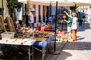 Seville, İspanya - 14 Temmuz 2022 Mercadillo Historico Del Jueves olarak da bilinen bit pazarında satılan çeşitli eşyalar, yerel halk dar Calle Feria 'da pazarlık aramakla meşgul.