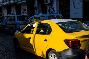 Tetouan, Morocco - August 17, 2022 Taxi driving through the streets of Tetouan during the coronavirus outbreak hitting Morocco, wearing a mask is mandatory