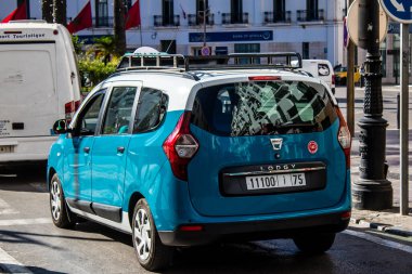 Tetouan, Morocco - August 17, 2022 Taxi driving through the streets of Tetouan during the coronavirus outbreak hitting Morocco, wearing a mask is mandatory