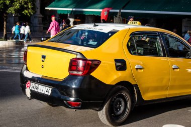Tetouan, Morocco - August 17, 2022 Taxi driving through the streets of Tetouan during the coronavirus outbreak hitting Morocco, wearing a mask is mandatory