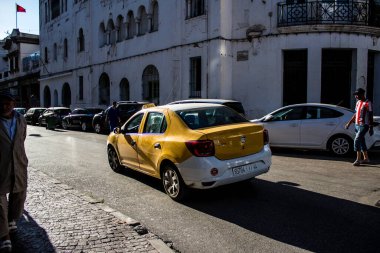 Tetouan, Morocco - August 17, 2022 Taxi driving through the streets of Tetouan during the coronavirus outbreak hitting Morocco, wearing a mask is mandatory